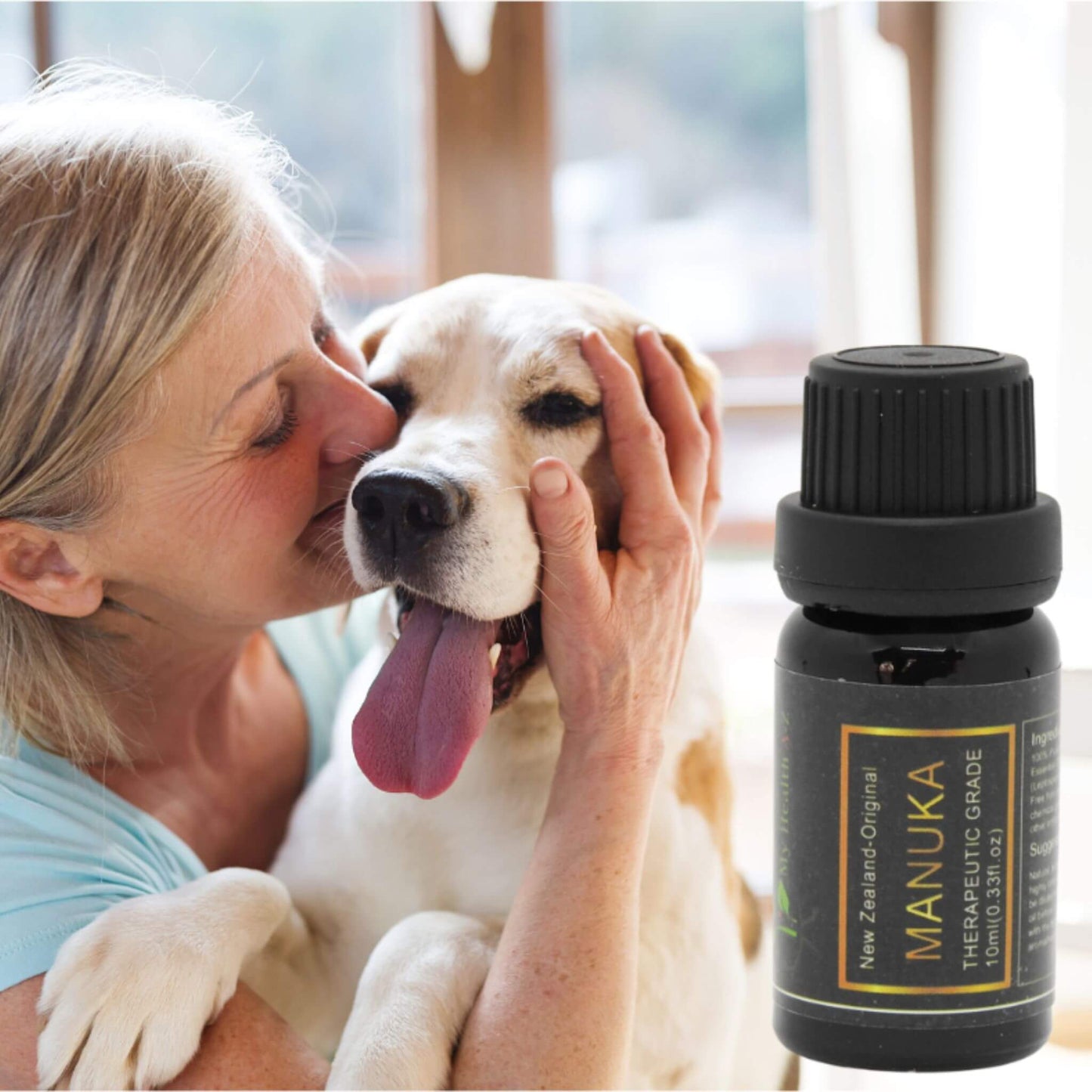 Woman petting a dog with a bottle of Manuka oil in the foreground