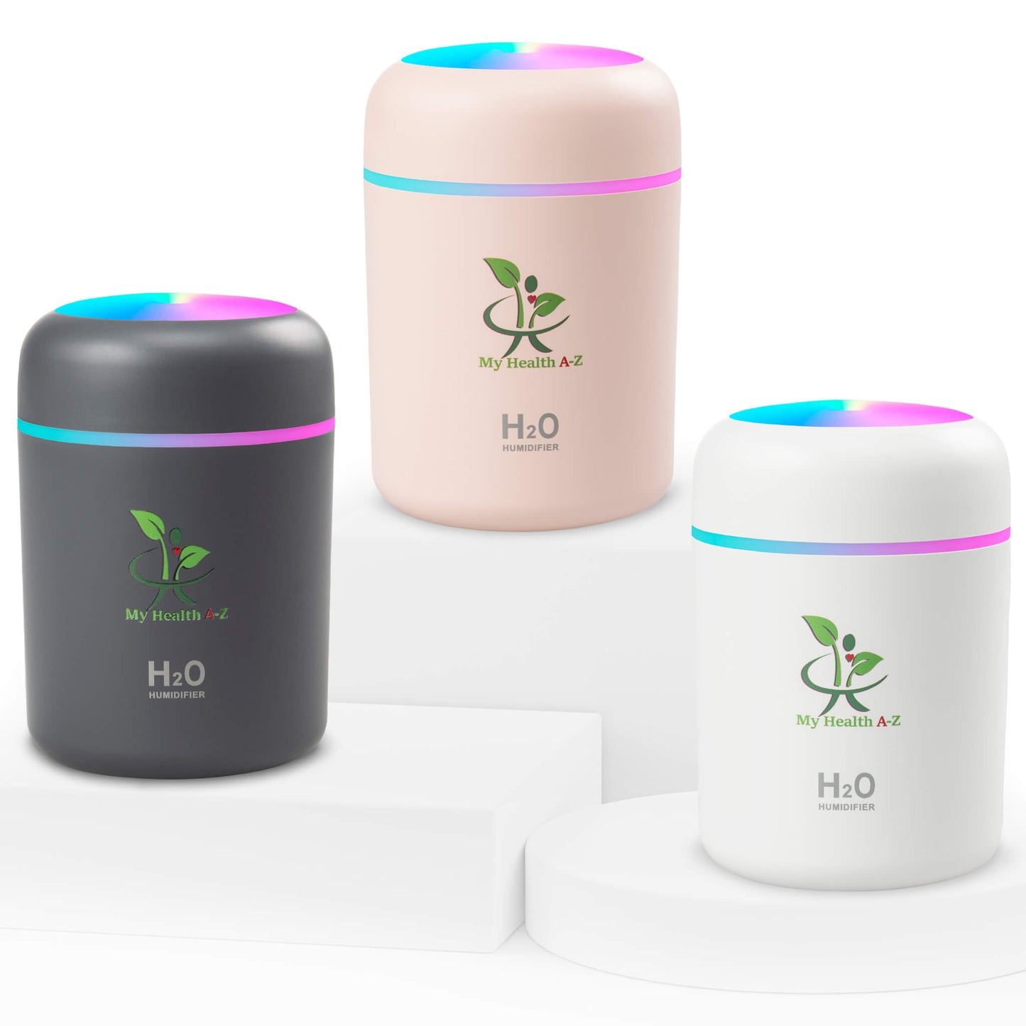 Three cylindrical humidifiers in black, pink, and white with colorful LED lights on a white background.