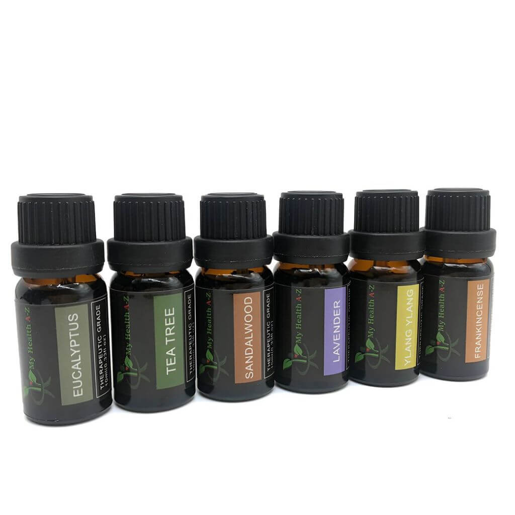Set of essential oil bottles with labels on a white background