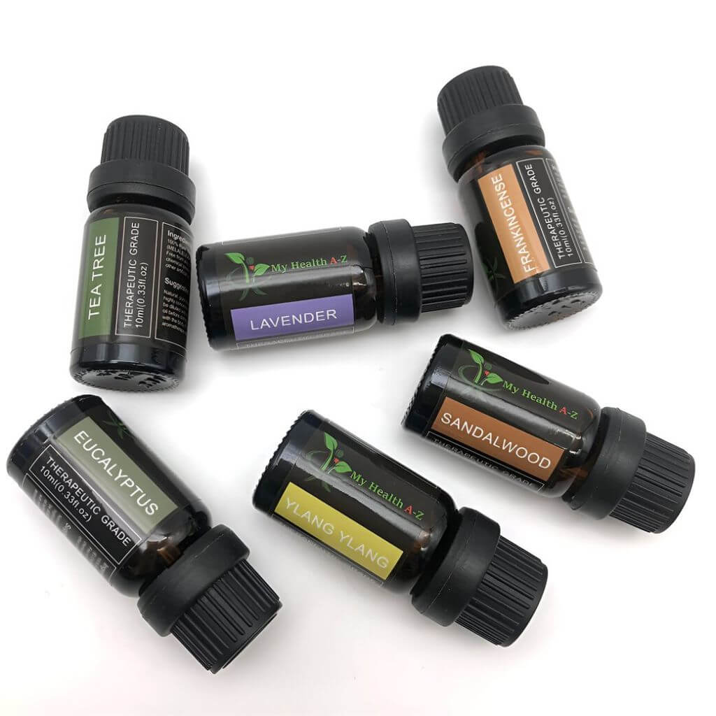 Collection of essential oil bottles with labels on a white background