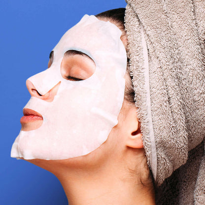 anti-ageing sheet mask woman wearing a face mask