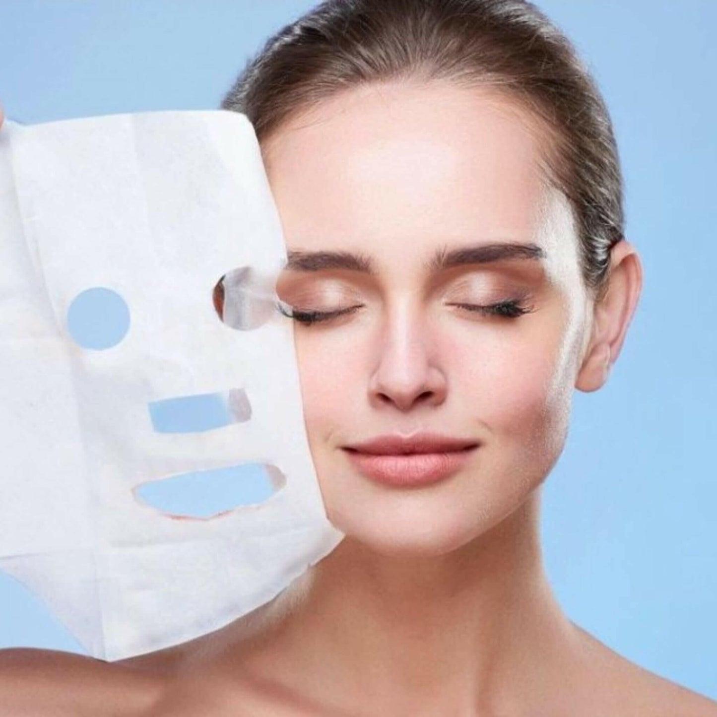 women taking off an anti-ageing sheet mask