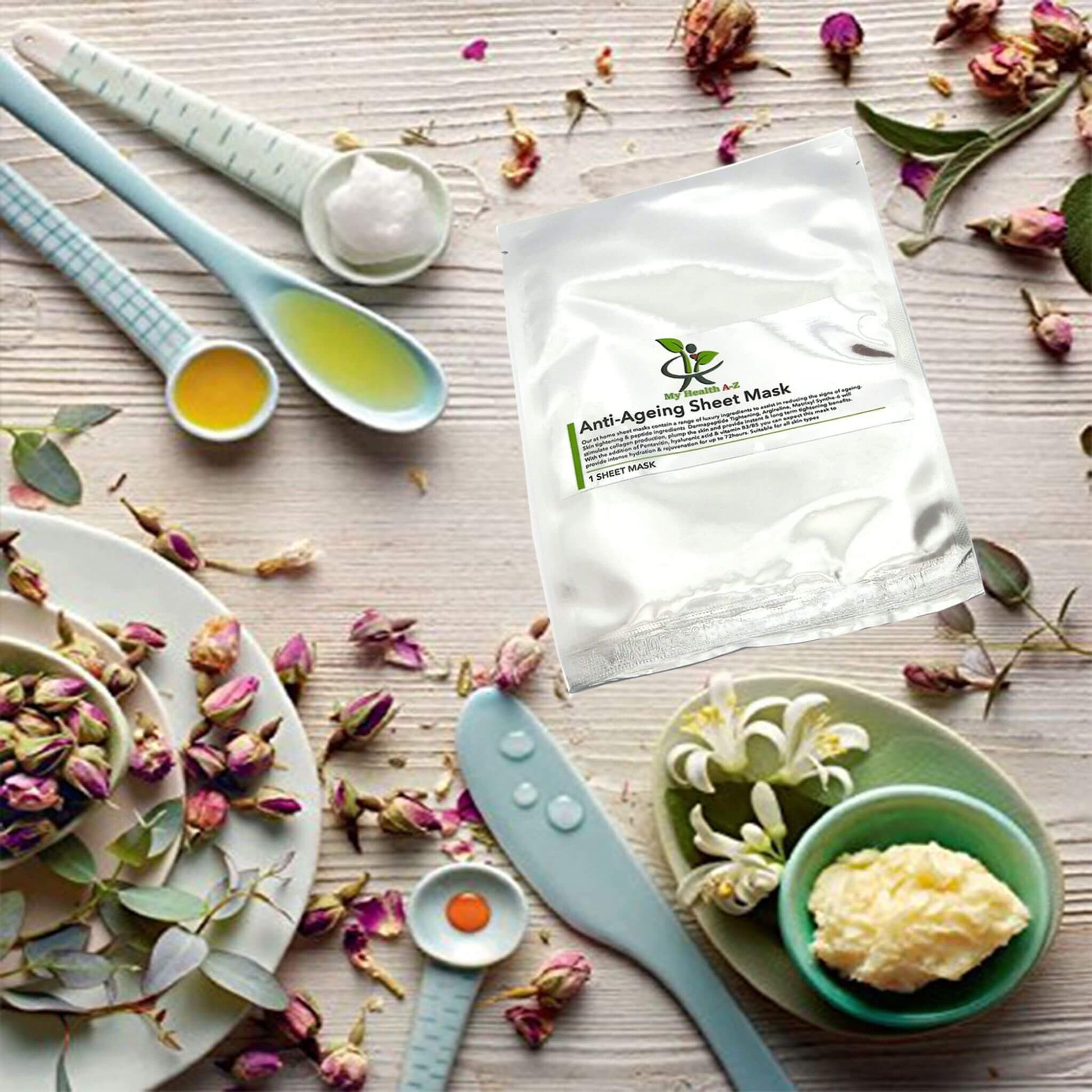 Anti-aging sheet mask with tools and ingredients on a wooden surface