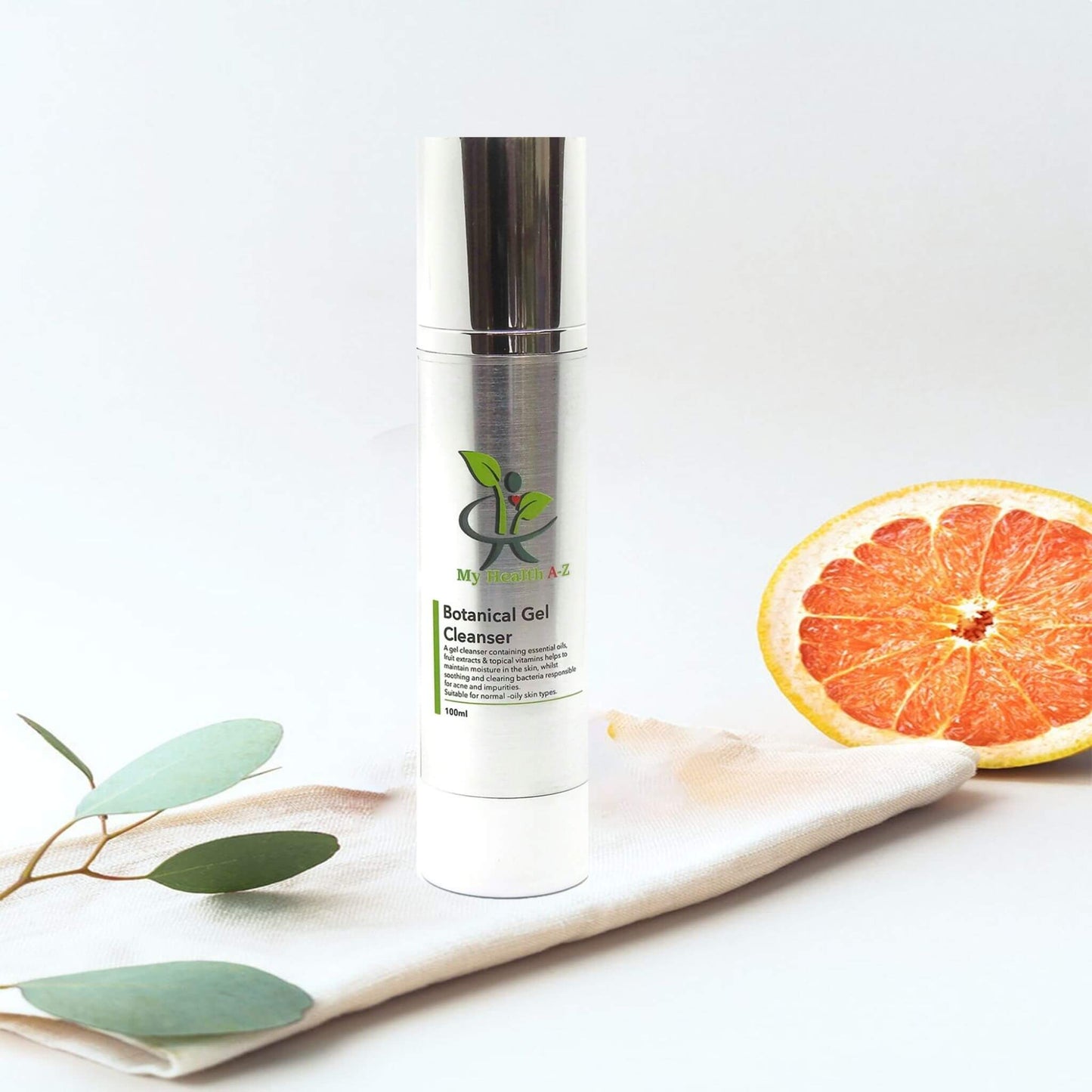 Skincare bottle labeled 'Botanical Gel Cleanser' with a grapefruit and leaves on a white background