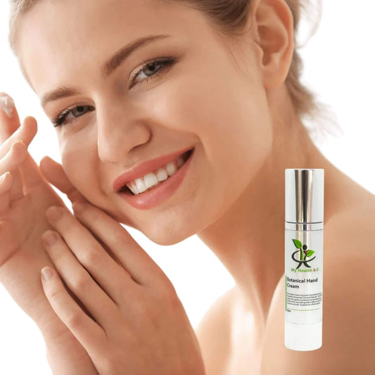Woman applying cream to hands with a bottle of cream labeled on a white background