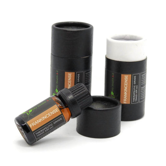 Frankincense essential oil bottle with black cap and labels on a white background