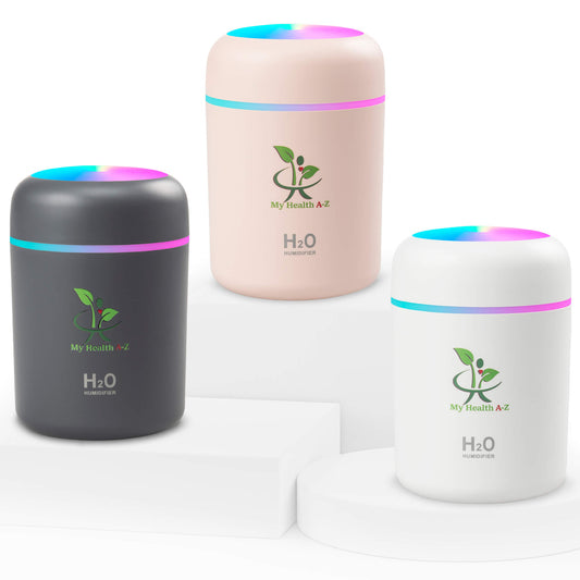 Three cylindrical humidifiers in black, pink, and white with colorful LED lights on a white background.