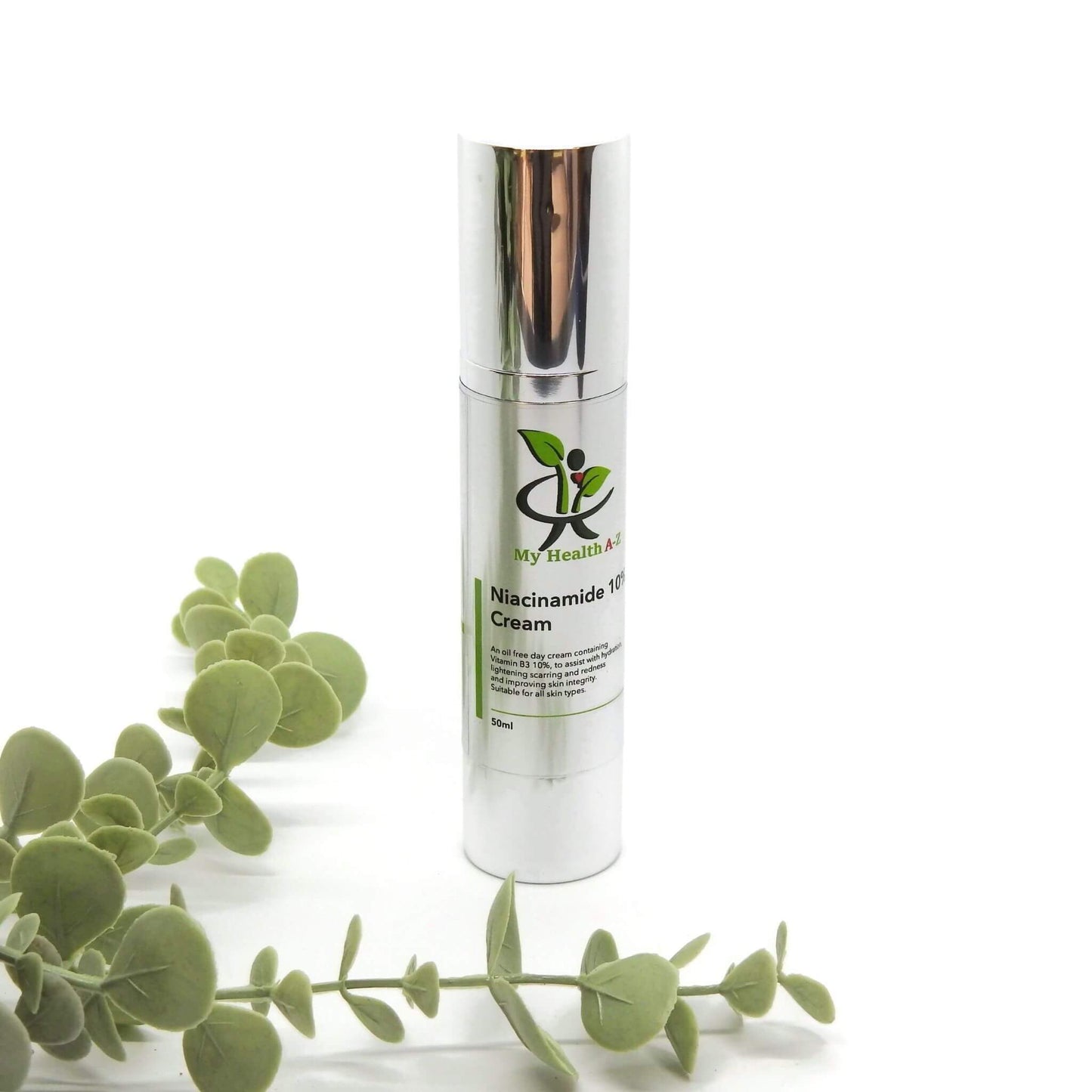 Skincare cream bottle with green leaves on a white background