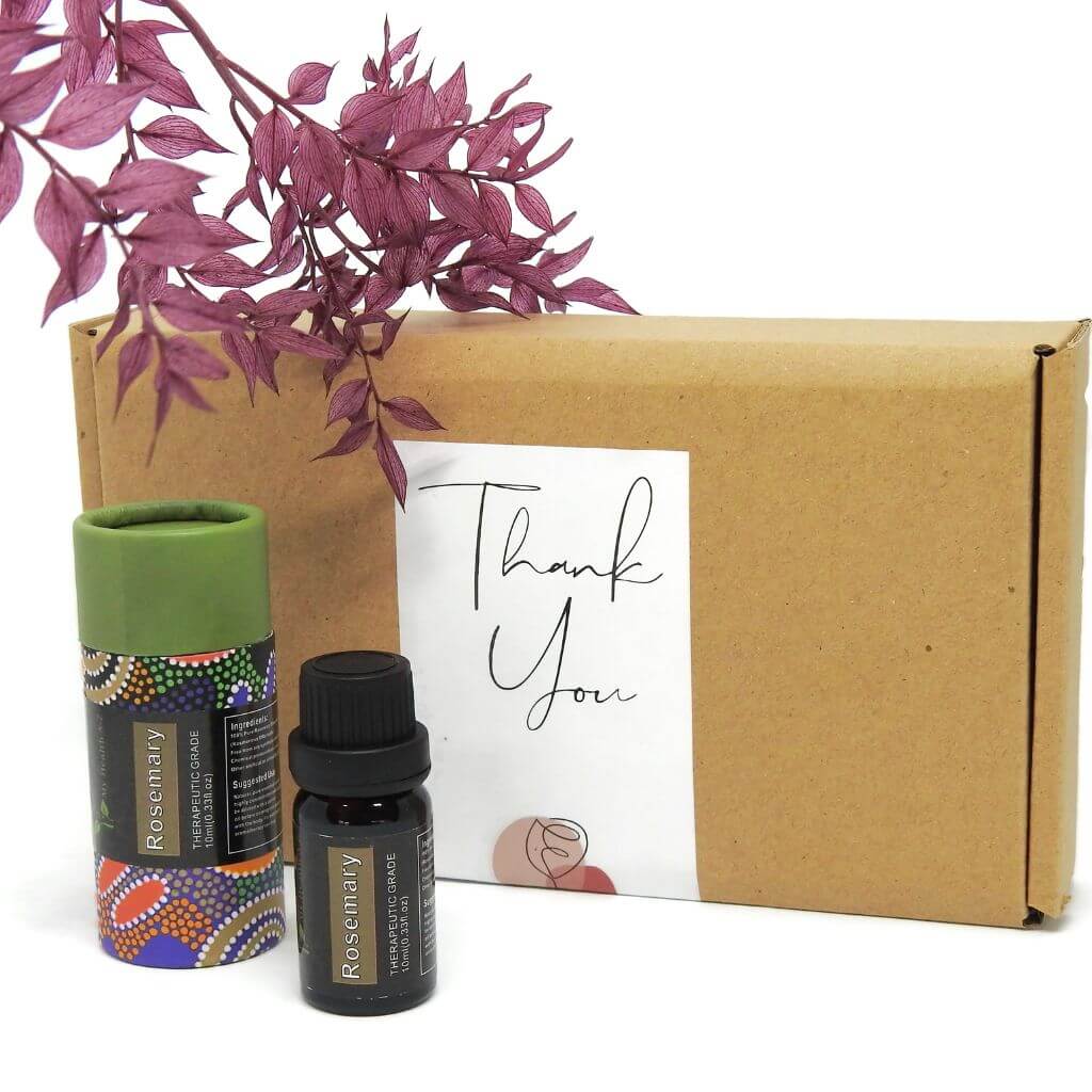 Two essential oil bottles and a cardboard box with a 'Thank You' card on a white background.