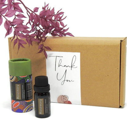 Two essential oil bottles and a cardboard box with a 'Thank You' card on a white background.