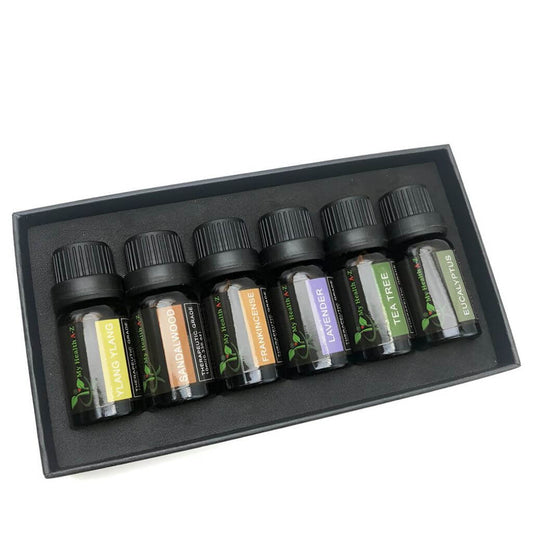 Set of essential oil bottles in a black box on a white background