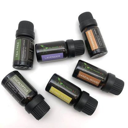 Collection of essential oil bottles with labels on a white background