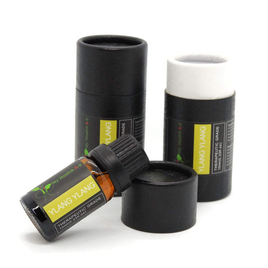 Ylang Ylang essential oil bottle with black cap and black cylindrical container on a white background